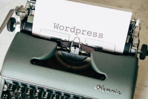 Close-up of a vintage typewriter with a paper displaying 'Wordpress' in retro style. Best Web Hosting for WordPress in 2026